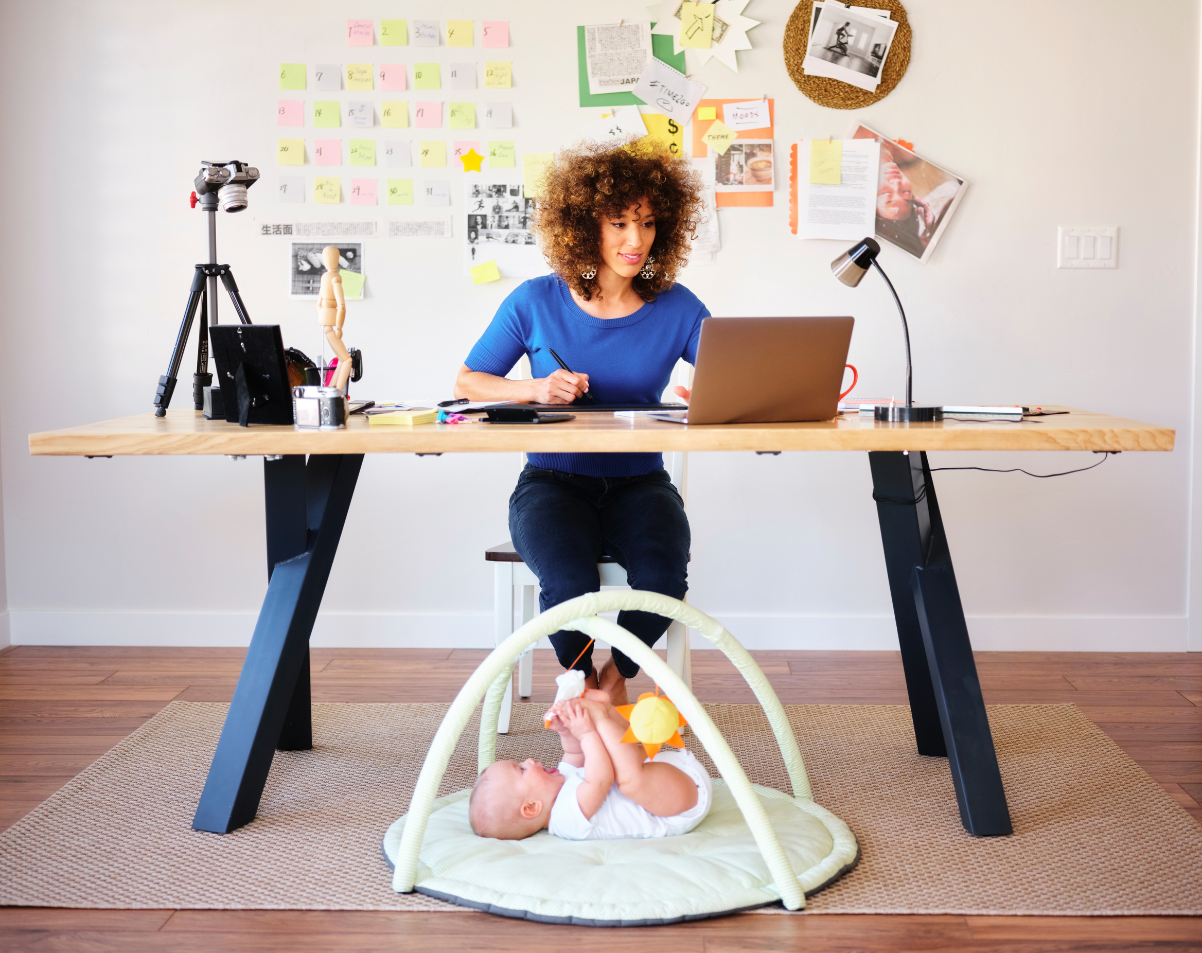 Working Mother Balancing Baby and Design Work